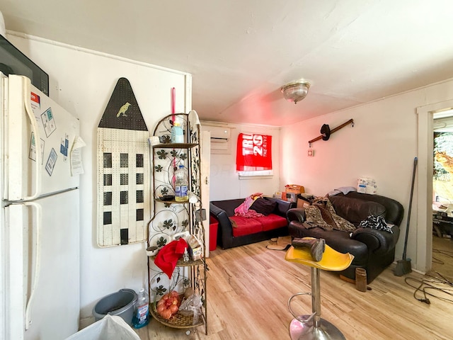 interior space with hardwood / wood-style flooring and a wall unit AC