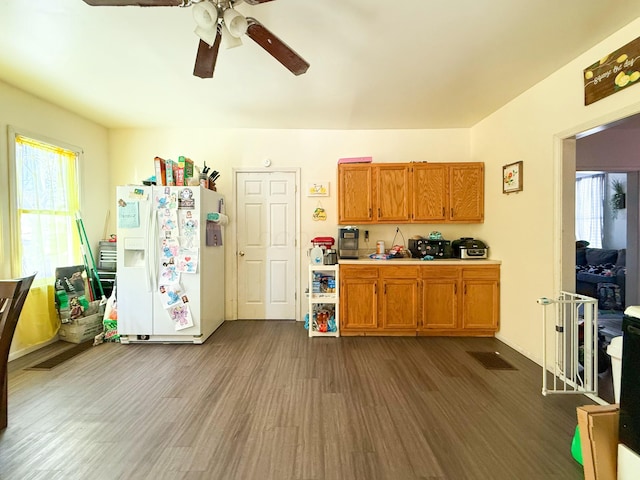 kitchen with white fridge with ice dispenser, dark hardwood / wood-style floors, and ceiling fan