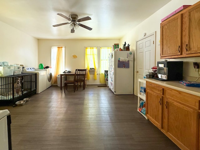 kitchen featuring washer and dryer, dark hardwood / wood-style floors, white refrigerator, and ceiling fan