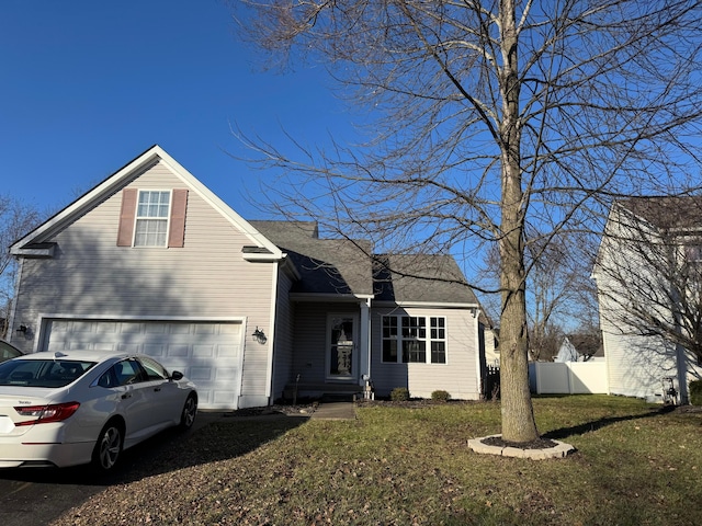 view of front of house featuring a front lawn and a garage