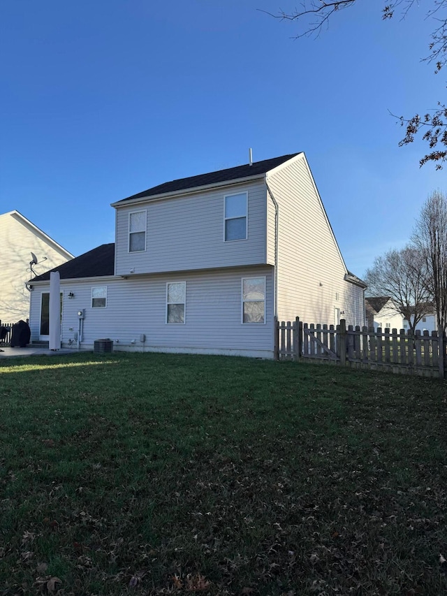 view of side of property with a lawn and cooling unit