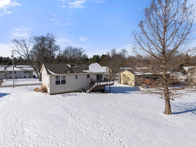 snow covered property with a deck