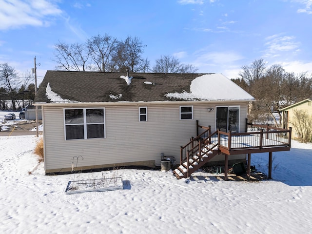 snow covered property with a wooden deck