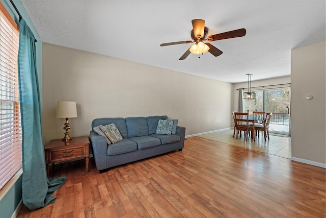 living room with ceiling fan and hardwood / wood-style floors