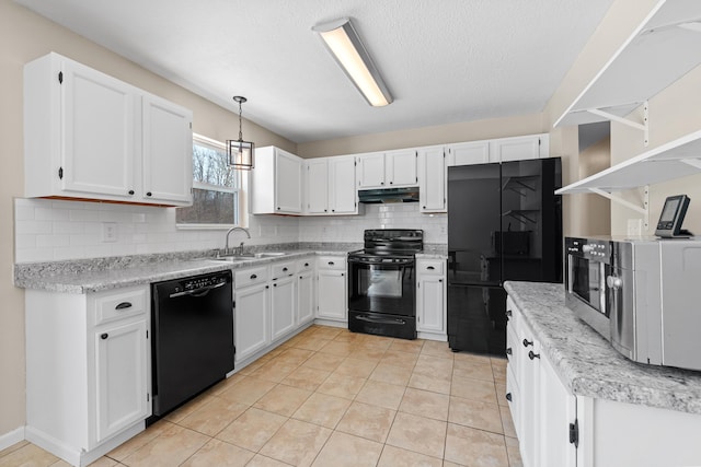 kitchen with sink, decorative light fixtures, white cabinetry, and black appliances