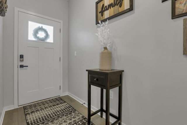 foyer entrance with dark hardwood / wood-style floors