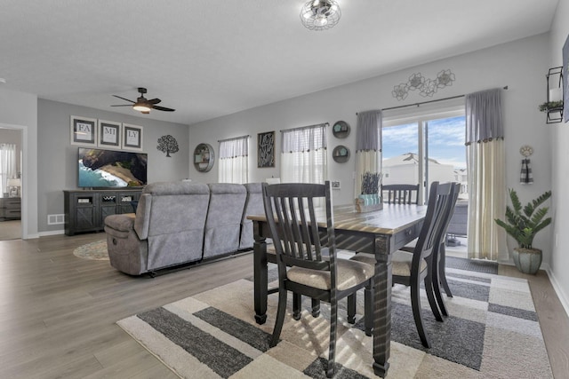 dining space featuring ceiling fan and light hardwood / wood-style flooring