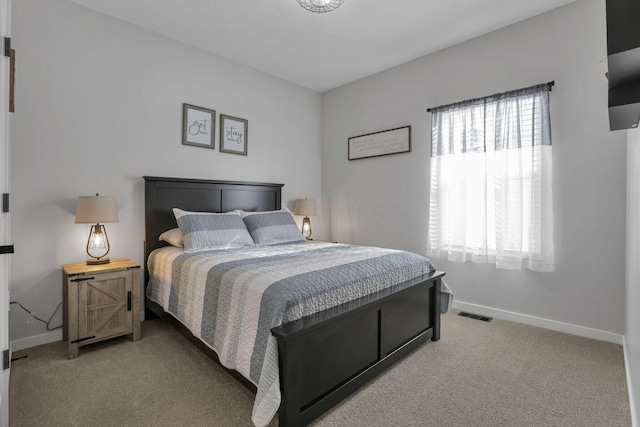 bedroom featuring light colored carpet and multiple windows