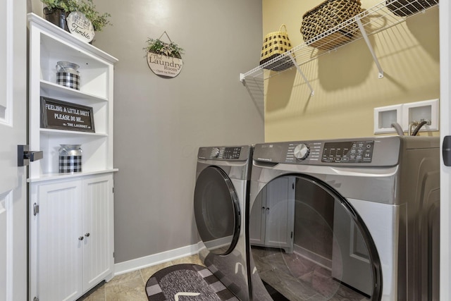 laundry area with washing machine and clothes dryer and tile patterned floors