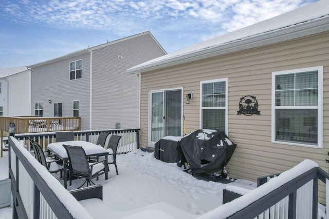 snow covered deck featuring area for grilling