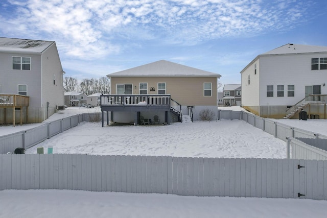 view of snow covered rear of property