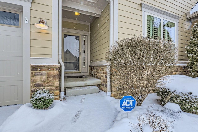 view of snow covered property entrance