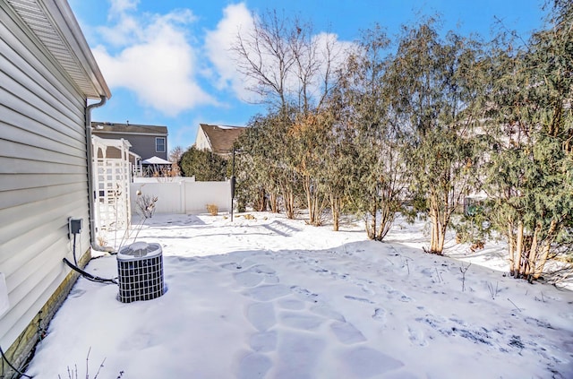 yard covered in snow with cooling unit