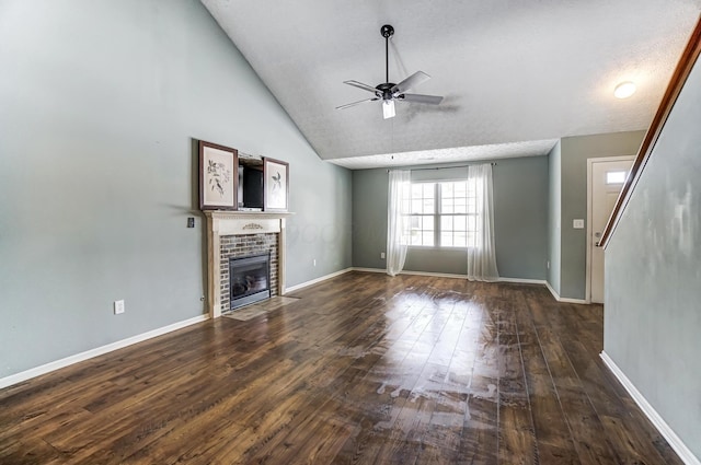 unfurnished living room with lofted ceiling, ceiling fan, a fireplace, a textured ceiling, and dark hardwood / wood-style flooring