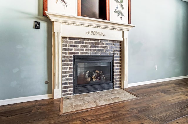 interior details with wood-type flooring and a fireplace