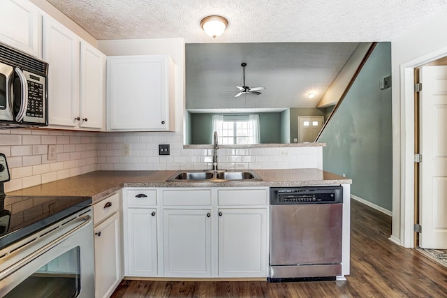 kitchen with sink, ceiling fan, appliances with stainless steel finishes, white cabinetry, and kitchen peninsula