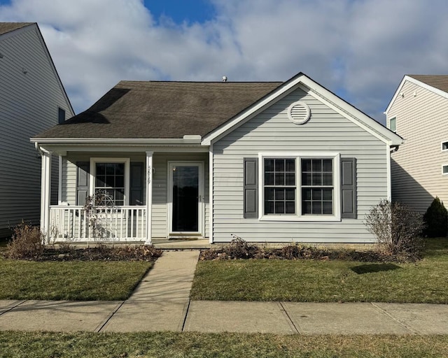 view of front of property with covered porch and a front yard