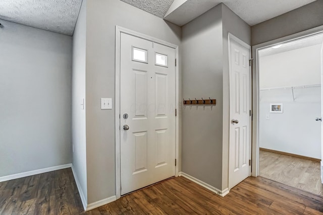 foyer entrance with dark hardwood / wood-style floors