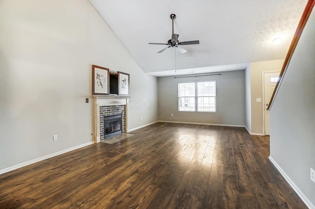 unfurnished living room featuring ceiling fan, dark hardwood / wood-style floors, high vaulted ceiling, and a fireplace