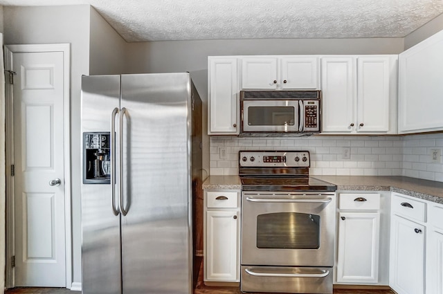 kitchen with white cabinetry, tasteful backsplash, stainless steel appliances, and a textured ceiling