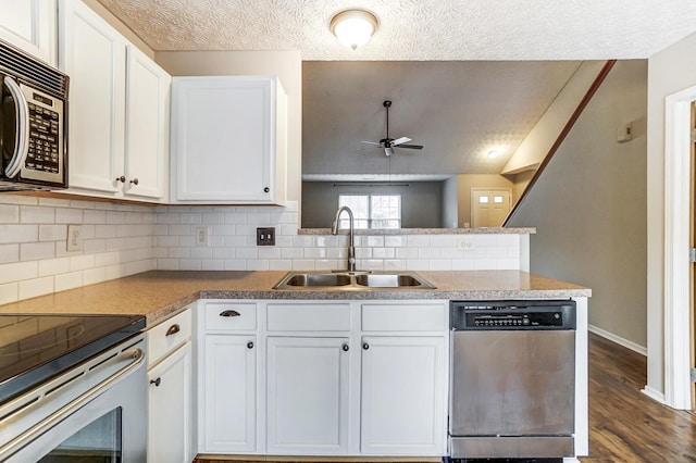 kitchen with stainless steel appliances, sink, and white cabinets