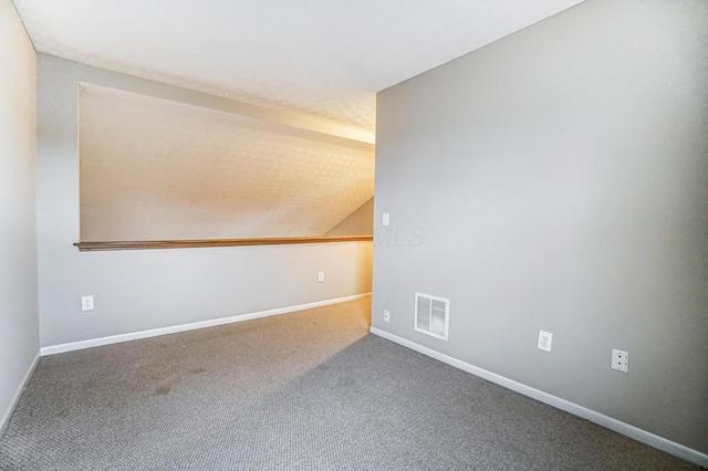 unfurnished room with lofted ceiling and carpet