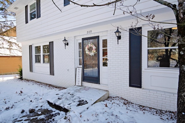 view of snow covered property entrance