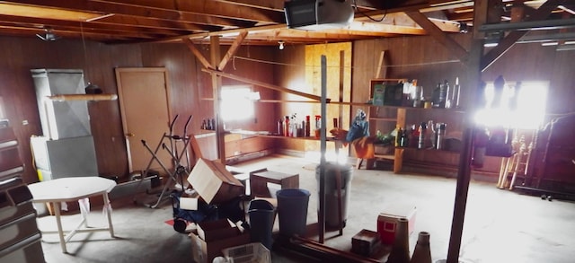 interior space with concrete flooring and wood walls