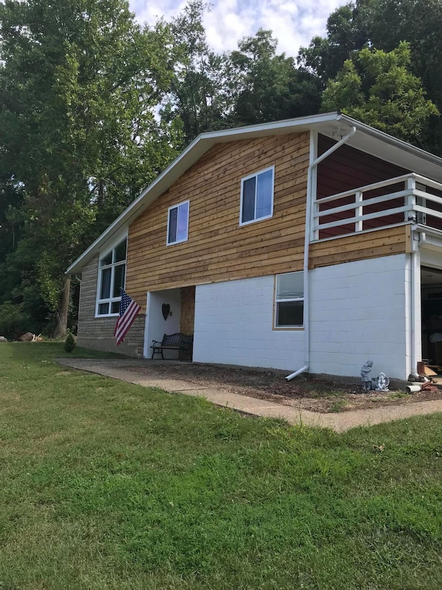 rear view of property featuring a yard