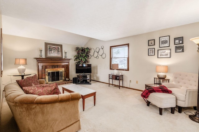 living room with a fireplace, vaulted ceiling, and light carpet