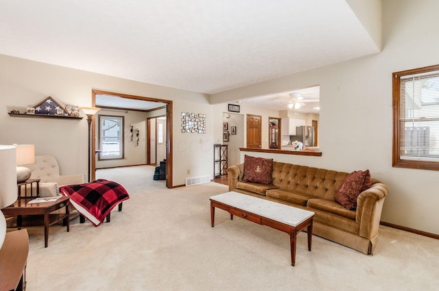 carpeted living room with plenty of natural light