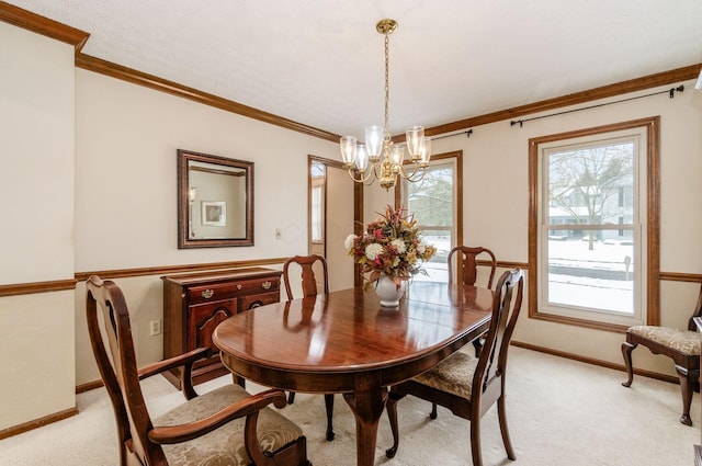 dining area with ornamental molding, light carpet, and an inviting chandelier