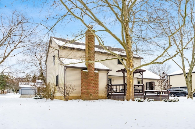 view of snow covered back of property