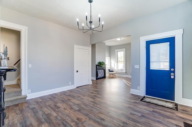 foyer entrance featuring dark hardwood / wood-style floors and an inviting chandelier