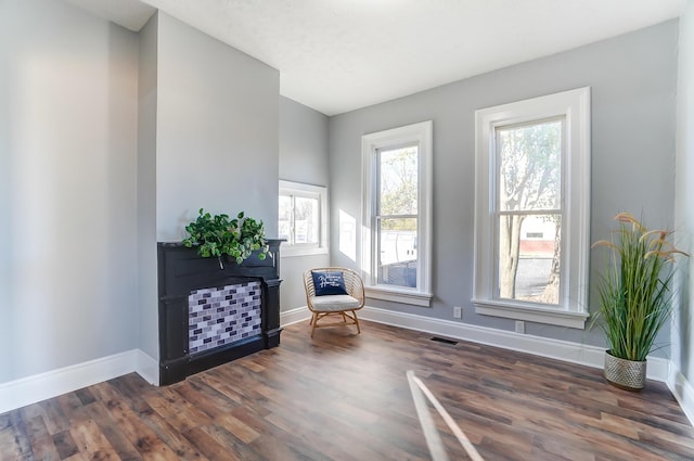 sitting room with dark hardwood / wood-style flooring