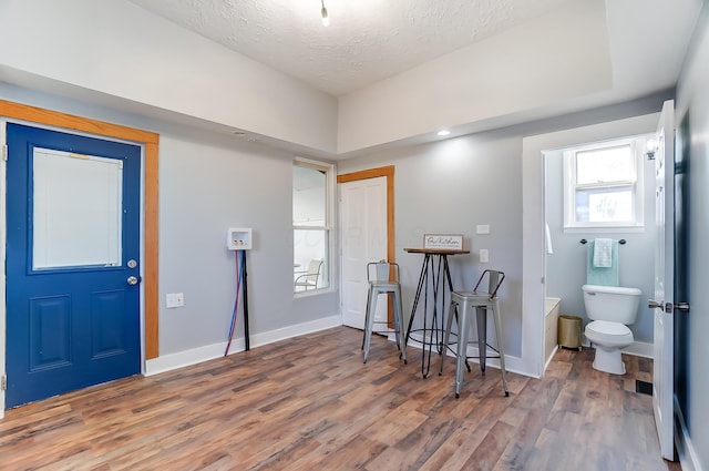 entrance foyer with hardwood / wood-style floors and a textured ceiling