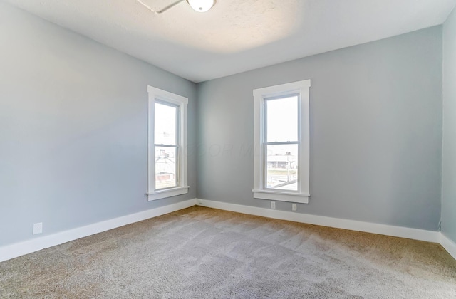 carpeted empty room with a wealth of natural light