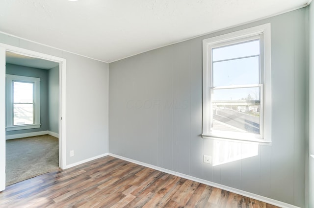 empty room with hardwood / wood-style floors