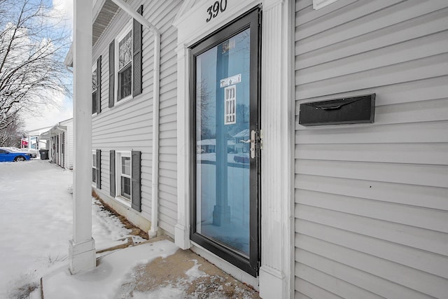 view of snow covered property entrance