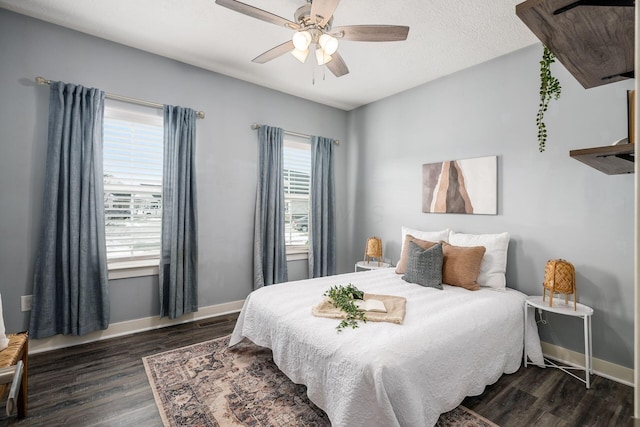 bedroom with ceiling fan and dark hardwood / wood-style flooring