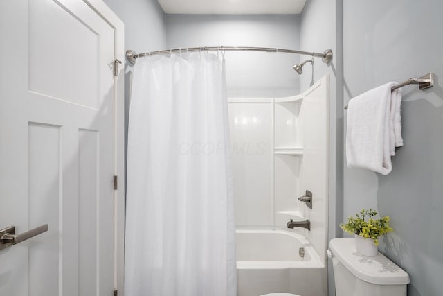 bathroom with shower / tub combo with curtain and toilet