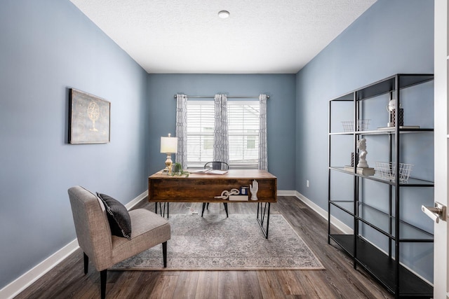 office with dark wood-type flooring and a textured ceiling