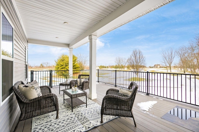 deck featuring an outdoor hangout area and a water view