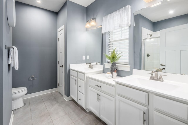 bathroom featuring vanity, tile patterned floors, a shower with door, and toilet