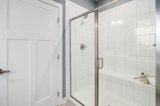 bathroom with a shower with door