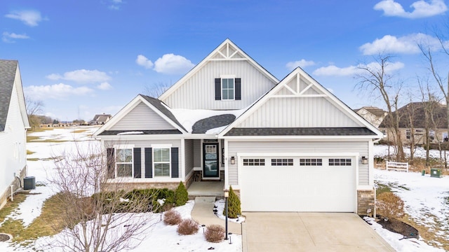 view of front of property with a garage and central AC