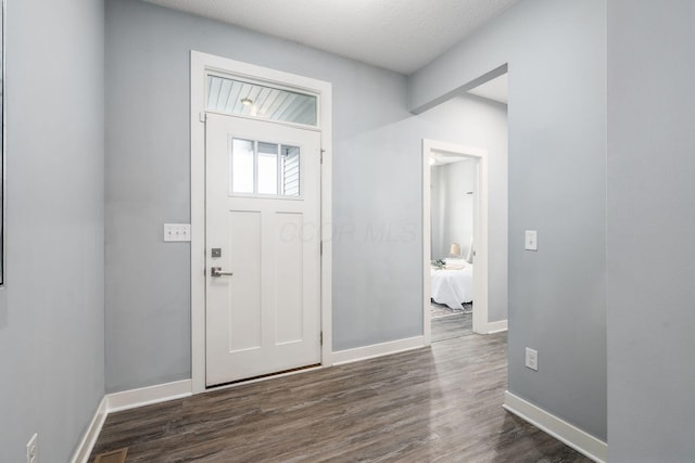 foyer entrance with dark hardwood / wood-style flooring