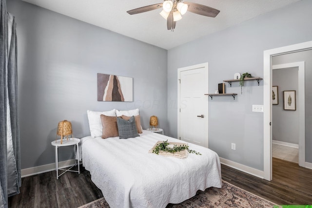 bedroom featuring ceiling fan, dark hardwood / wood-style flooring, and a textured ceiling