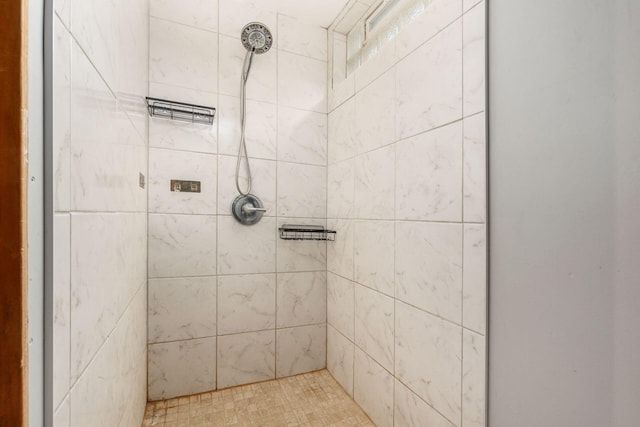 bathroom with tiled shower