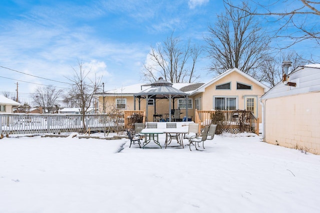 snow covered rear of property featuring a gazebo and a wooden deck